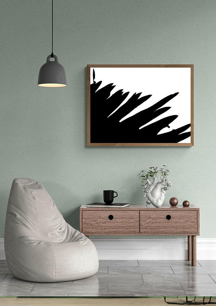Modern living room with a bean bag chair, coffee table, and black and white printable abstract art on the wall.