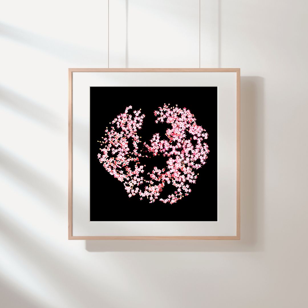 Printable wall art featuring pink blossom in a circle pattern set against a black background, displayed in a wooden frame.